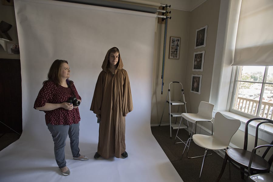 Tammy Fraley of Fraley Photography, left, shares a smile with Schuyler Smith of Vancouver as he is dressed as Obi-Wan Kenobi on Wednesday afternoon in downtown Vancouver. Fraley had previously taken Smith’s portrait and the two reunited to have their photo taken together.