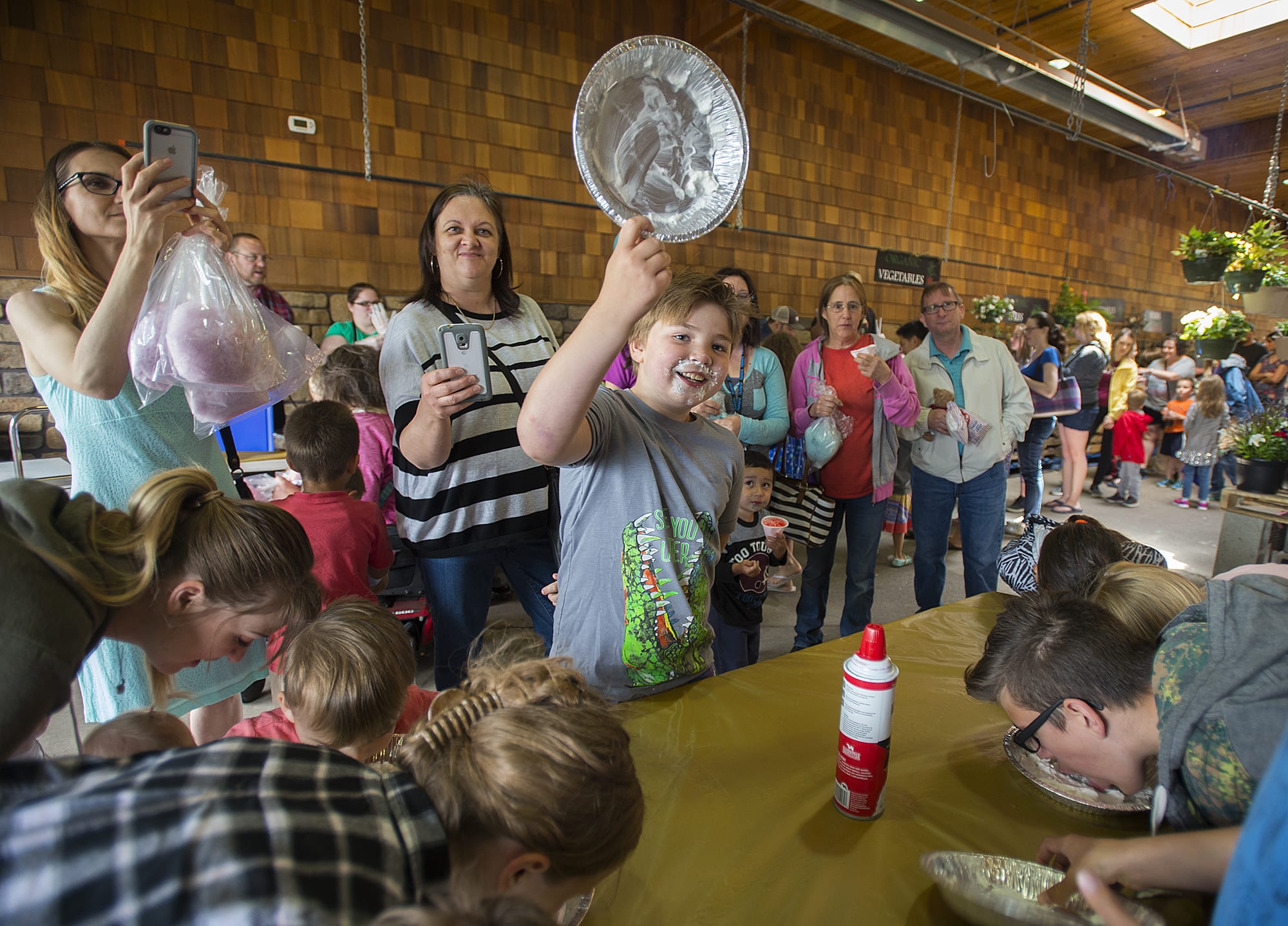Camas resident Ryder Smith, 10, is all smiles as he wins a round of the whipped cream pie eating content during Chuck's Carnival Kid's Day at Chuck's Produce in Southeast Vancouver on Monday afternoon, June 25, 2018. The event, which was free to the public, featured a variety of games, cotton candy, snow cones, popcorn, a cupcake walk and prizes.