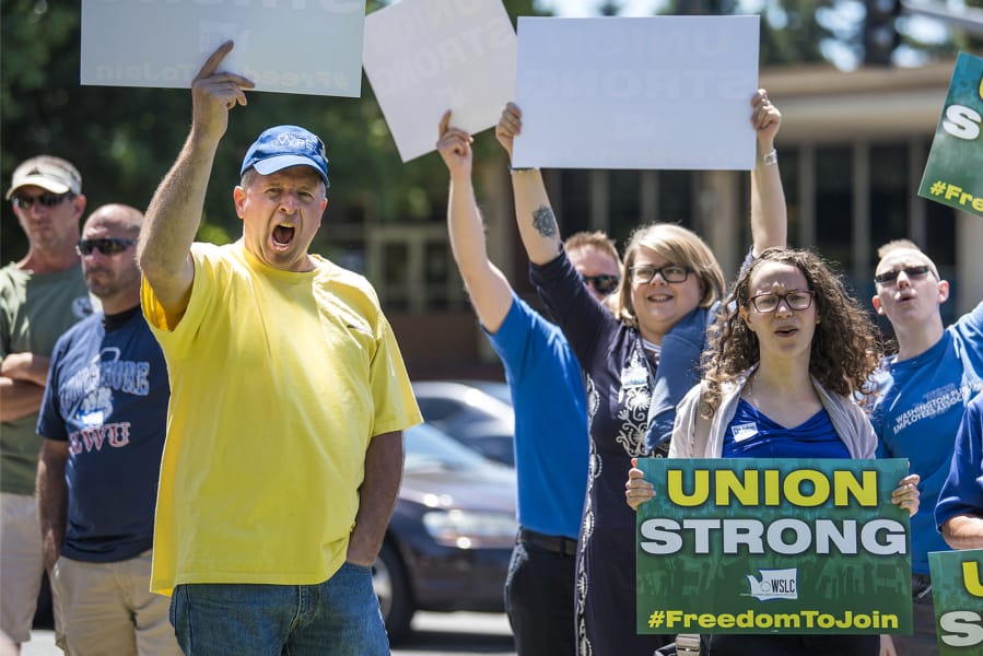 Union members and supporters rally against the U.S. Supreme Court’s decision in Janus v. AFSCME at the corner of Fort Vancouver Way and East Mill Plain Boulevard on Wednesday afternoon.