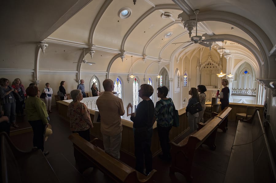 Employees from Providence Health & Services pause to take in the view from the chapel balcony at Providence Academy during a Wednesday tour of the historic building in Vancouver.