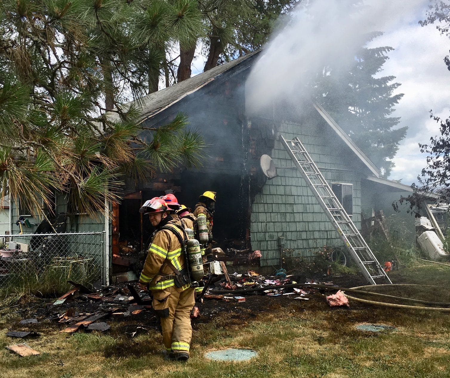 Firefighters work on a house fire near Battle Ground Monday.
