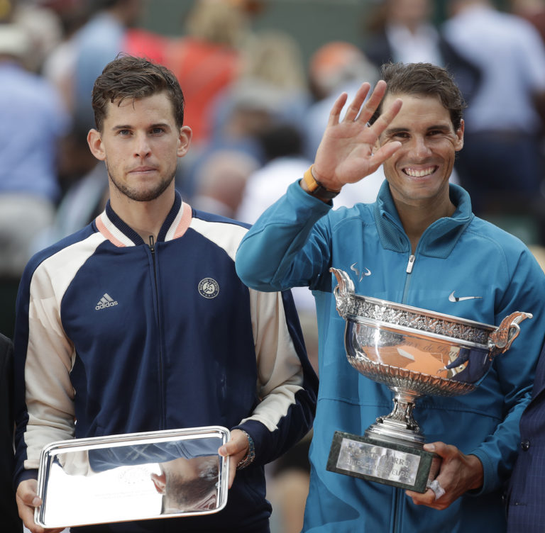 Eleven-times French Open winner Spain's Rafael Nadal, right, and runner-up Austria's Dominic Thiem hold the trophies after the men's final match of the French Open tennis tournament at the Roland Garros stadium in Paris, France, Sunday, June 10, 2018.