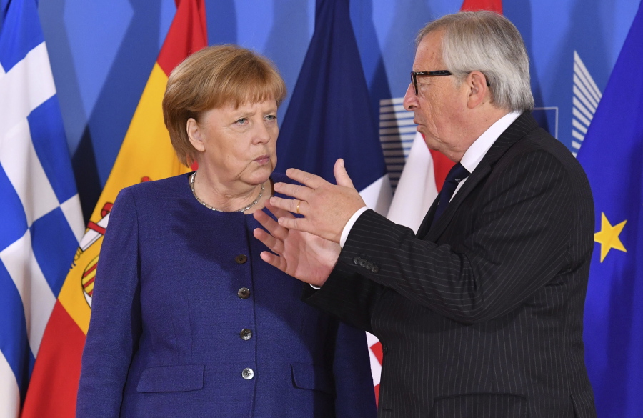 Geert Vanden Wijngaert/Associated Press European Commission President Jean-Claude Juncker, right, speaks with German Chancellor Angela Merkel during an informal EU summit on migration at EU headquarters in Brussels, Sunday, June 24, 2018.