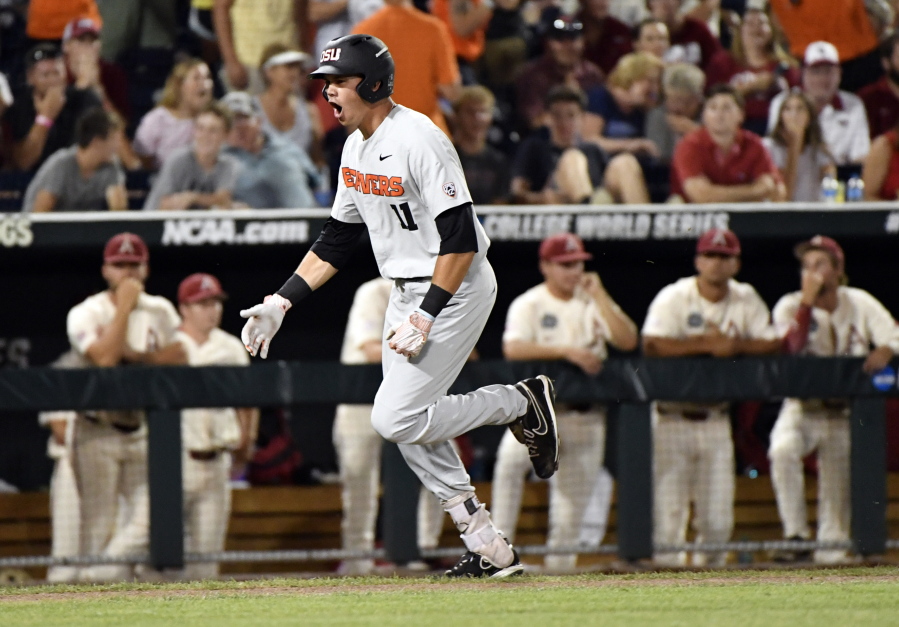Oregon State's Trevor Larnach (11) celebrates his two-run home run against Arkansas during the ninth inning in Game 2 of the NCAA College World Series baseball finals in Omaha, Neb., Wednesday, June 27, 2018.