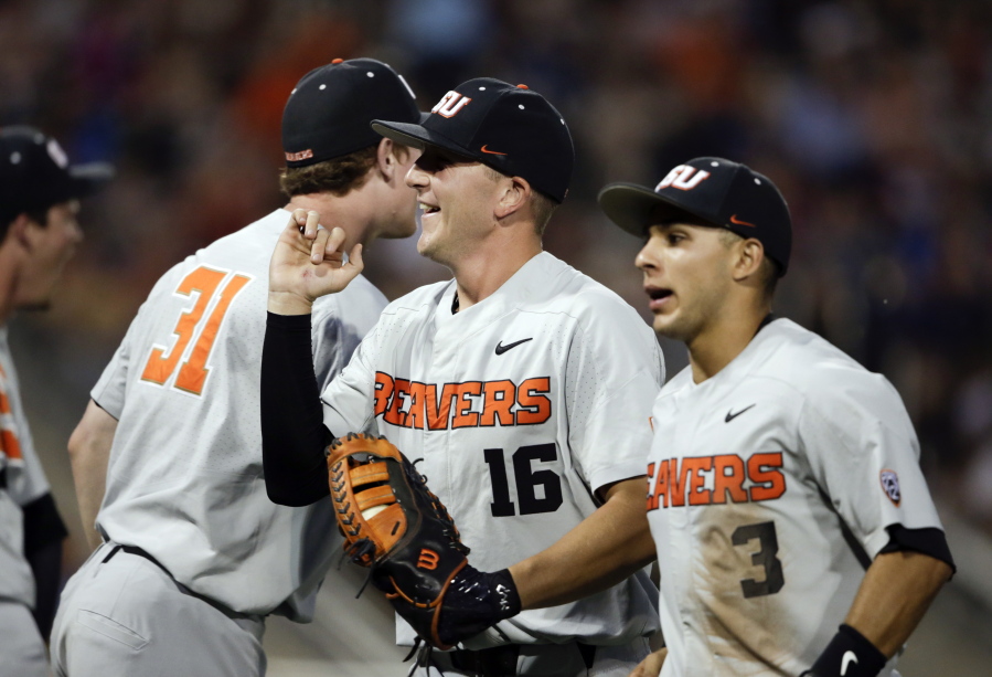 Oregon State first baseman Zak Taylor (16) smiles after a double play against Mississippi State ended the sixth inning of an NCAA College World Series baseball elimination game in Omaha, Neb., Saturday, June 23, 2018.