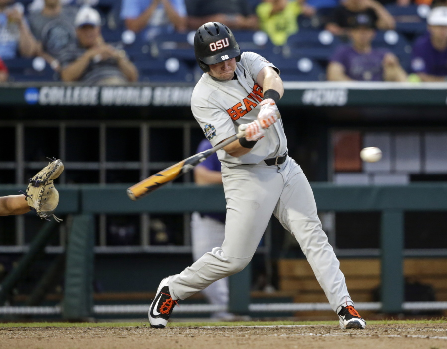 Oregon State designated hitter Kyle Nobach (28) hits a three-run home run in the seventh inning of an NCAA College World Series baseball elimination game against Washington in Omaha, Neb., Monday, June 18, 2018. Oregon State won 14-5.