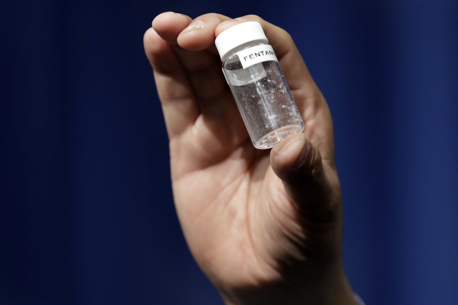 A reporter holds up an example of the amount of fentanyl that can be deadly after a news conference about deaths from fentanyl exposure, at The Drug Enforcement Administration headquarters in Arlington, Va., on June 6, 2017. The House dove Tuesday into a two-week vote-a-thon on dozens of bills aimed at opioid abuse, as lawmakers try to tackle a crisis that’s killing tens of thousands a year and to score a popular win they can tout for the midterm elections. A handful of the measures are contentious, including one Republican bill that would create new criminal penalties for making or trafficking certain synthetic drugs containing fentanyl.
