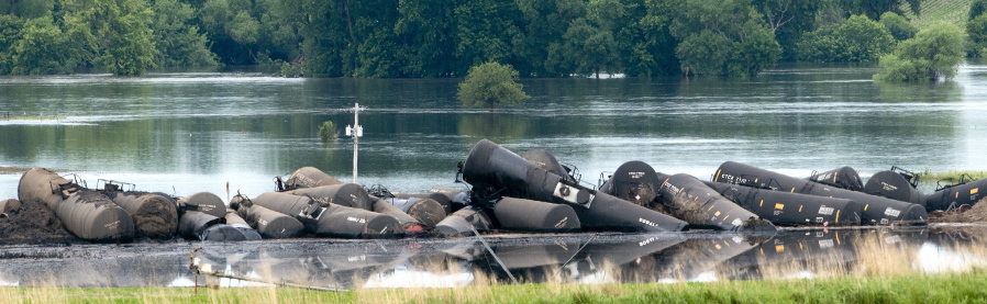 Tank cars carrying crude oil are shown derailed Friday near Doon, Iowa.