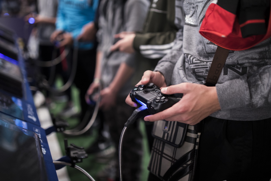 A man plays a game at the Paris Games Week in Paris. The World Health Organization says that compulsively playing video games now qualifies as a new mental health condition, in a move that some critics warn may risk stigmatizing its young players.