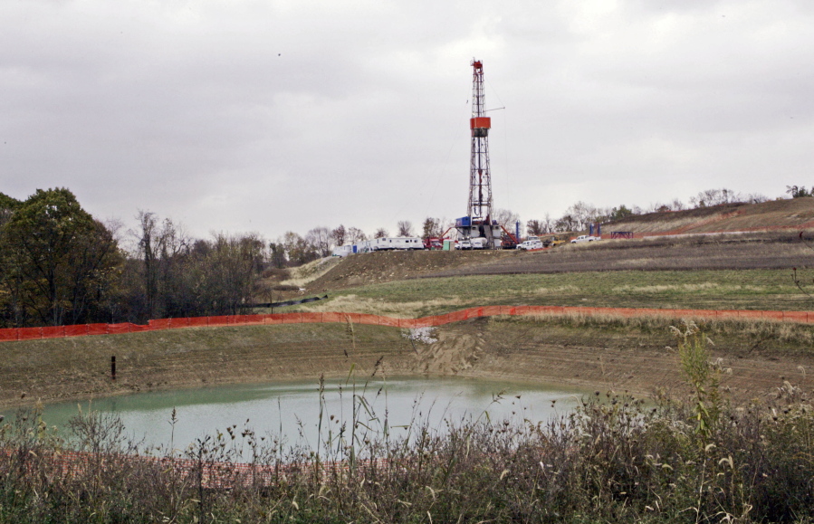 A drilling rig used to extract natural gas from the Marcellus Shale is seen in October 2008 on a hill above a pond on a farm in the Washington County borough of Houston, Pa.