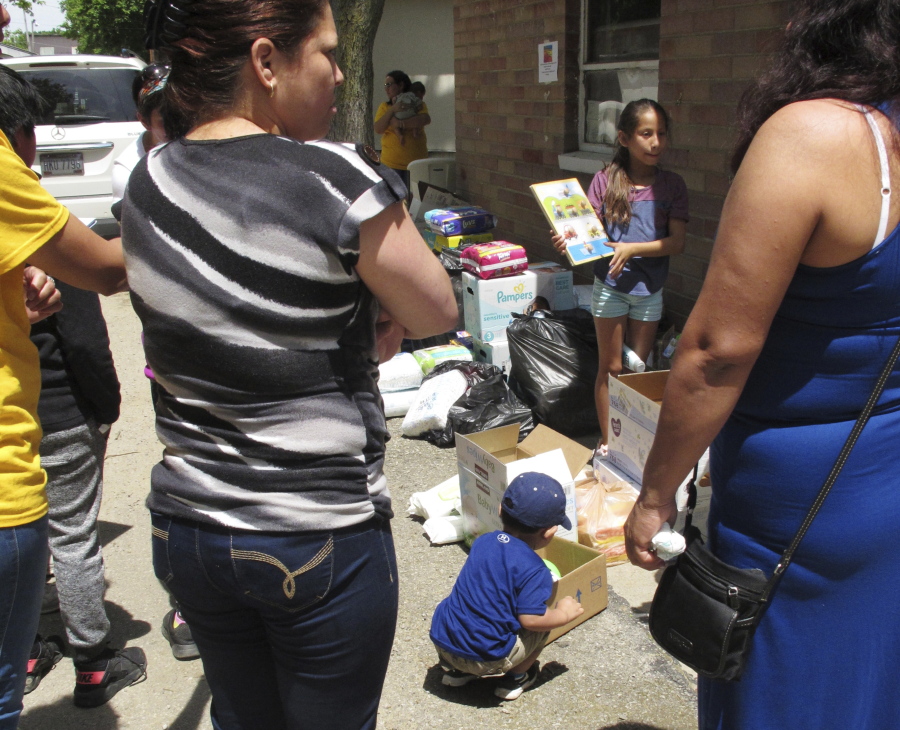 A boy picks out a soccer ball from donations delivered to an Ohio trailer park in Norwalk, Ohio, June 15. Community members have donated diapers, baby wipes, food and clothing for the families of workers arrested in an immigration raid at a garden and landscaping company in early June.