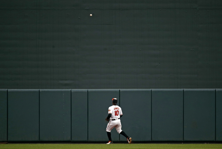 Baltimore Orioles center fielder Adam Jones watches a a solo home run Seattle Mariners' Ryon Healy during the second inning of a baseball game Wednesday, June 27, 2018, in Baltimore.
