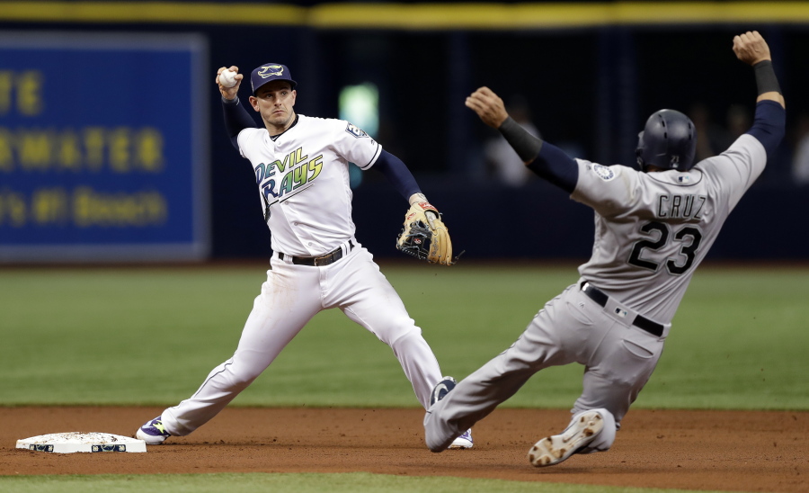 Tampa Bay Rays shortstop Daniel Robertson left, forces Seattle Mariners’ Nelson Cruz at second base on a fielder’s choice by Kyle Seager during the first inning of a baseball game Saturday, June 9, 2018, in St. Petersburg, Fla.