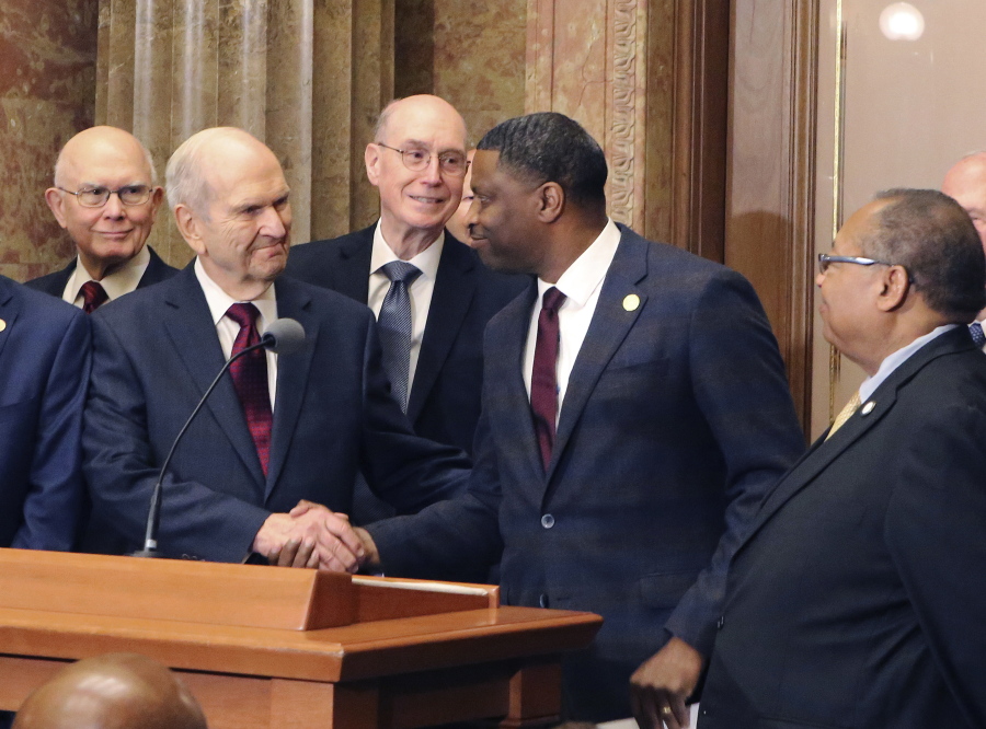 Mormon church President Russell M. Nelson shakes hands with Derrick Johnson, president of the NAACP during a news conference, in Salt Lake City on May 17.