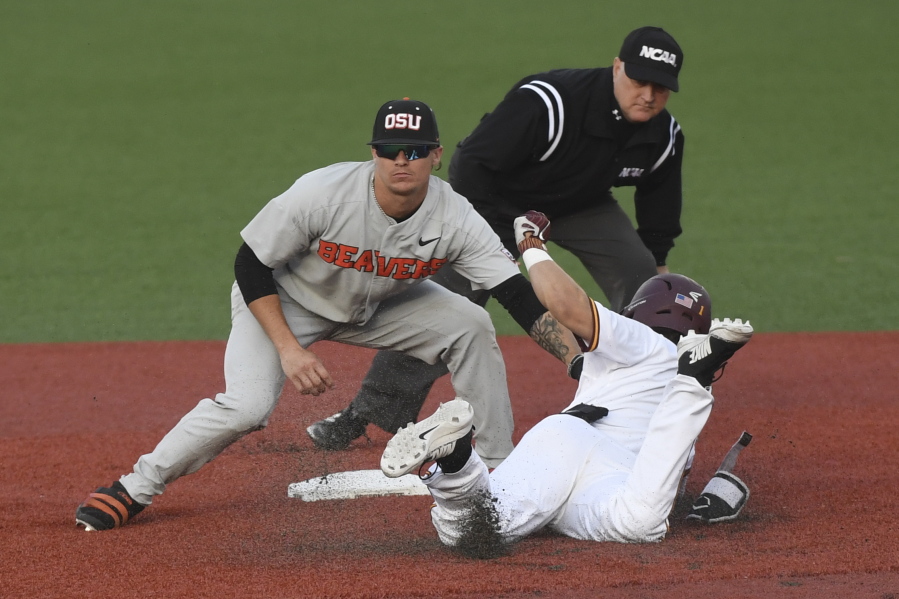 Oregon State shortstop Cadyn Grenier (2) tags out Minnesota’s Ben Mezzenga (1) during an NCAA college baseball tournament super regional game Saturday, June 9, in Corvallis, Ore.