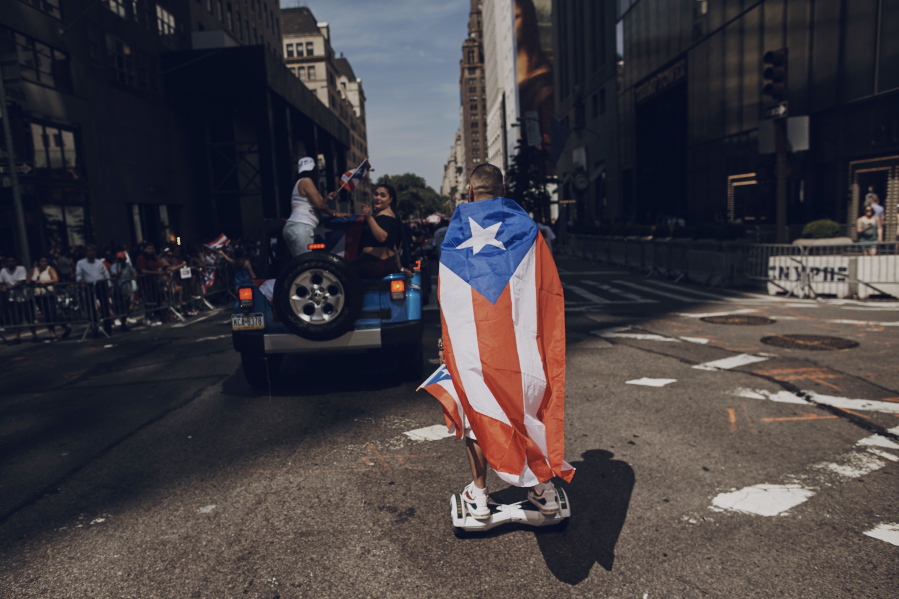A man rolls on a hover-board along Fifth Avenue on June 11, 2017 during the National Puerto Rican Day Parade in New York. Amid all the fun and celebration planned for this years parade on Sunday organizers and participants want to keep a spotlight on something serious. They want people to remember that months after Hurricane Maria roared through and as the next hurricane season arrives, Puerto Rico is still struggling.