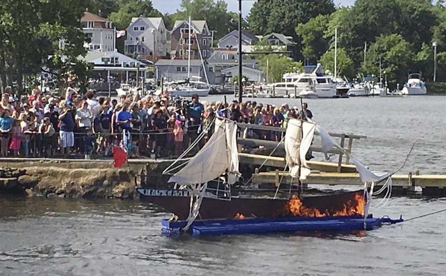 Spectators watch an annual ceremonial burning of a replica of the ship HMS Gaspee in Warwick, R.I. The British customs schooner Gaspee had been sent in March 1772 to enforce maritime trade laws and prevent smuggling around Newport, R.I. In June 1772, a colonial ship lured the Gaspee through shallow waters of Narragansett Bay where it ran aground and was subsequently burned by colonists.