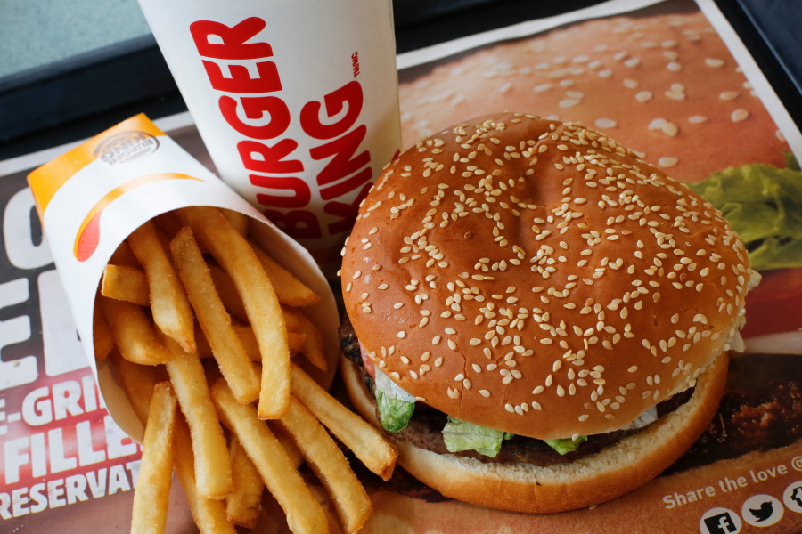 FILE- This Feb. 1, 2018, file photo shows a Burger King Whopper meal combo at a restaurant in the United States. Burger King says it’s sorry for offering a lifetime supply of Whoppers to Russian women who get pregnant from World Cup players. (AP Photo/Gene J.