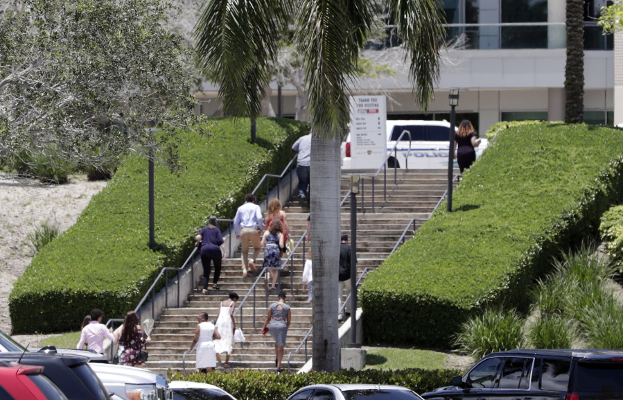 People arrive for a graduation ceremony for Marjory Stoneman Douglas seniors Sunday in Sunrise, Fla. The Class of 2018 will honor four members who were among those killed in February’s gun massacre at the school in Parkland, Fla.