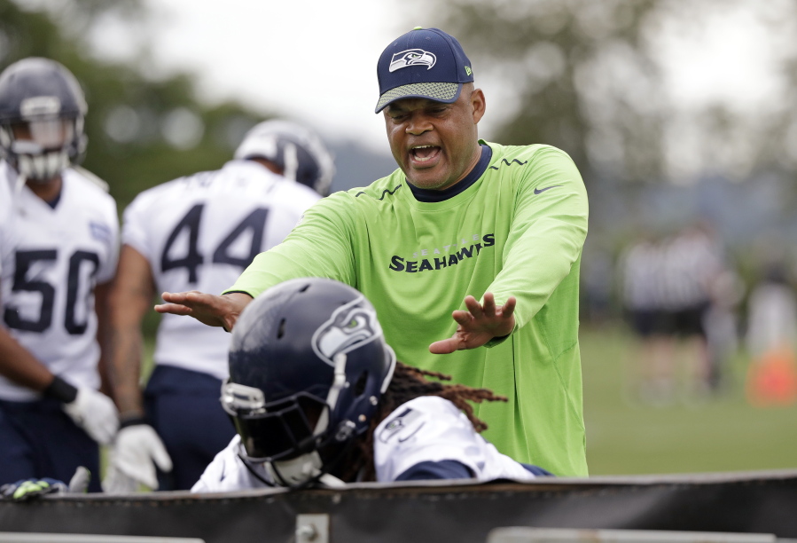 Seattle Seahawks defensive coordinator Ken Norton Jr. directs players during an NFL football practice Thursday, June 7, 2018, in Renton, Wash.