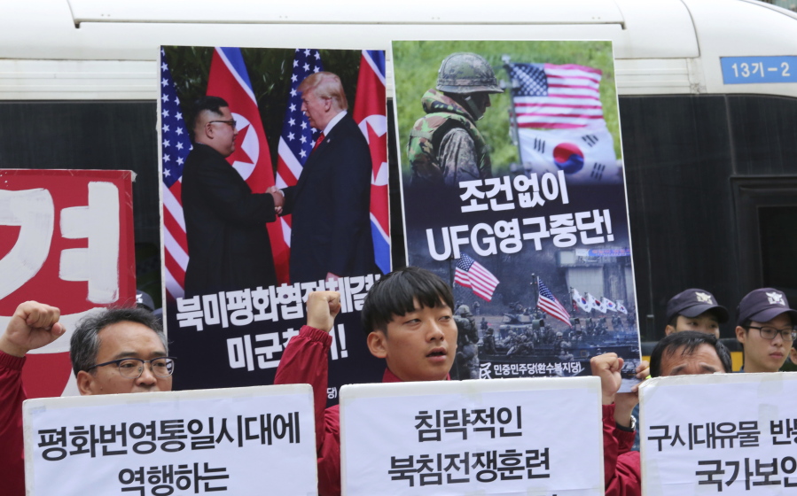 Members of the People’s Democratic Party shout slogans during a rally to oppose military exercises between the United States and South Korea on Friday near the U.S. embassy in Seoul, South Korea.