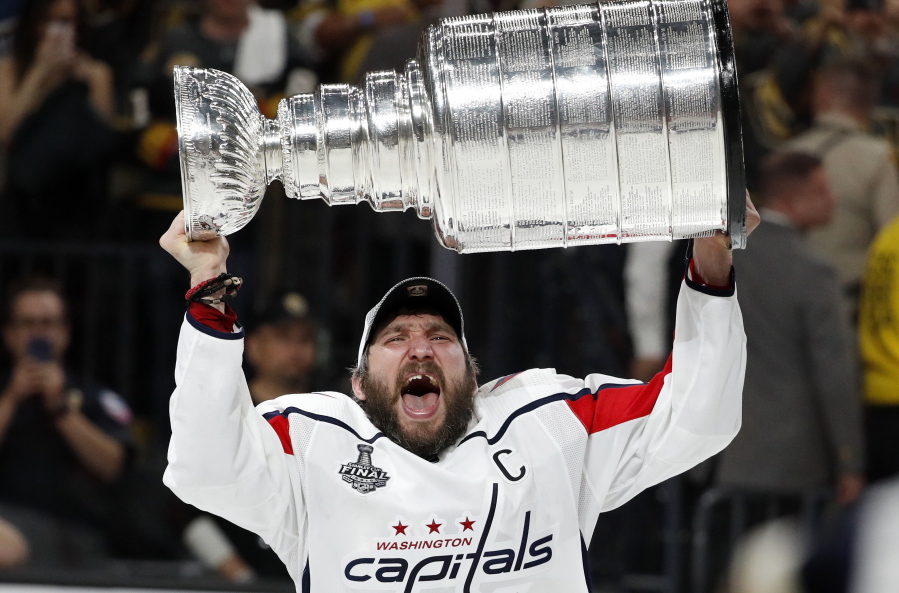 Washington Capitals left wing Alex Ovechkin, of Russia, hoists the Stanley Cup after the Capitals defeated the Golden Knights in Game 5 of the NHL hockey Stanley Cup Finals Thursday, June 7, 2018, in Las Vegas.