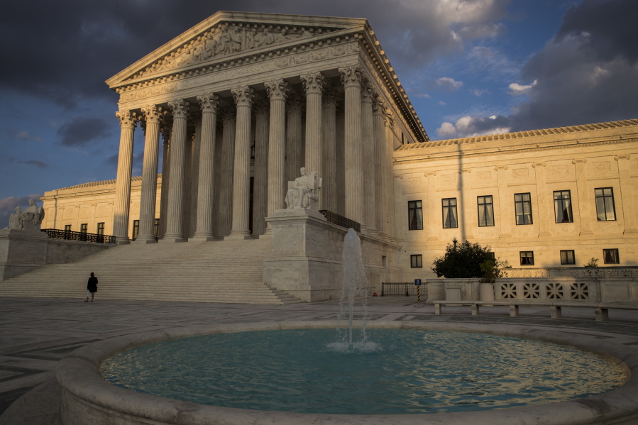 FILE - In this Oct. 10, 2017 file photo, the Supreme Court in Washington is seen at sunset. In a 5-4 decision Friday, The Supreme Court says police generally need a search warrant if they want to track criminal suspects’ movements by collecting information about where they’ve used their cellphones. (AP Photo/J.