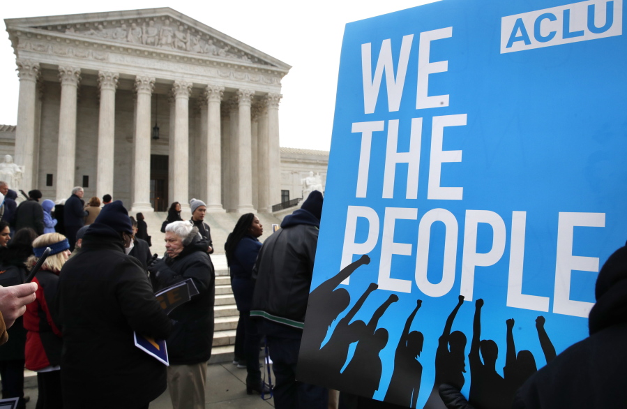People rally outside of the Supreme Court in opposition to Ohio’s voter roll purges in Washington. The Supreme Court is allowing Ohio to clean up its voting rolls by targeting people who haven’t cast ballots in a while.