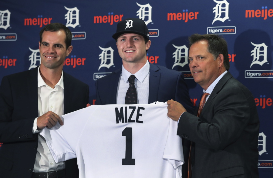 Detroit Tigers first overall pick Casey Mize, center, stands with Tigers scout Justin Henry, left, and Scott Pleis, director of amateur scouting, during a news conference where he was introduced to the media, Monday, June 25, 2018, in Detroit.