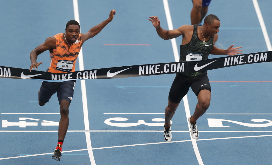Noah Lyles beats Ronnie Baker, right, to the finish line while winning the men’s 100 meters the U.S. Championships athletics meet Friday, June 22, 2018, in Des Moines, Iowa.