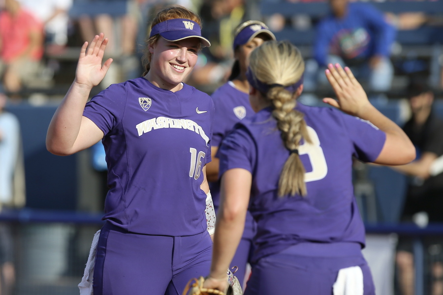 Washington’s Gabbie Plain (16) celebrates with Taylor Van Zee (3) after the second inning of an NCAA softball Women’s College World Series game against Oregon in Oklahoma City, Friday, June 1, 2018.