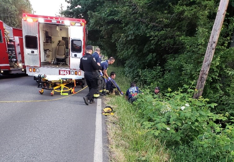 Emergency responders descended an embankment off Southeast Stiles Road in Washougal on Tuesday night to help an injured bicyclist who’d been struck by a car.