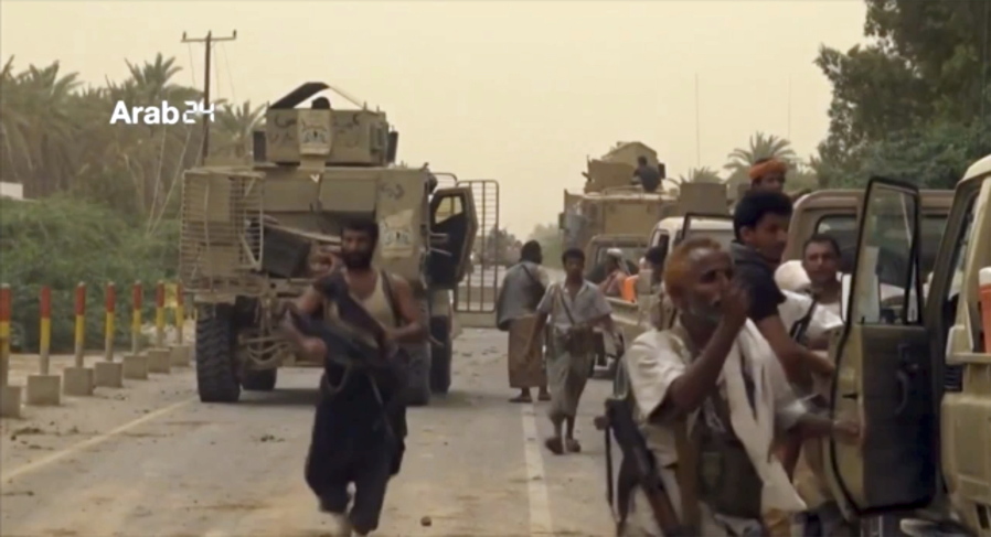 This still image taken from video provided by Arab 24 shows Saudi-led forces gathering to retake the international airport of Yemen’s rebel-held port city of Hodeida from the Shiite Houthi rebels Saturday, June 16, 2018. With battles raging at the southern side of al-Hodeida International Airport, the military of Yemen’s exiled government said it had entirely seized the facility, and that engineers were working to clear mines from nearby areas just south of the city of some 600,000 people on the Red Sea.