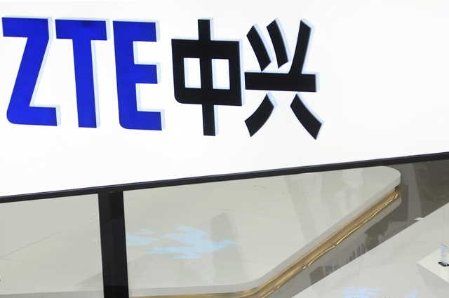 In this Feb. 26, 2014, file photo, a sign for the ZTE booth is seen at the Mobile World Congress, the world's largest mobile phone trade show in Barcelona, Spain. The United States has reached a deal with the Chinese telecommunications giant that includes a $1 billion fine, according to Commerce Secretary Wilbur Ross. Ross, speaking on CNBC on Thursday, June 7, 2018 said that a compliance team picked by the U.S. will be embedded at ZTE.