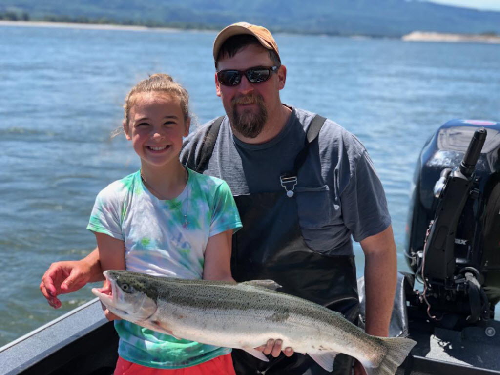 Guide Larry Werner poses with a youngster and a typical summer steelhead from the Columbia River. While this years runs are better than last year, they are still below average.