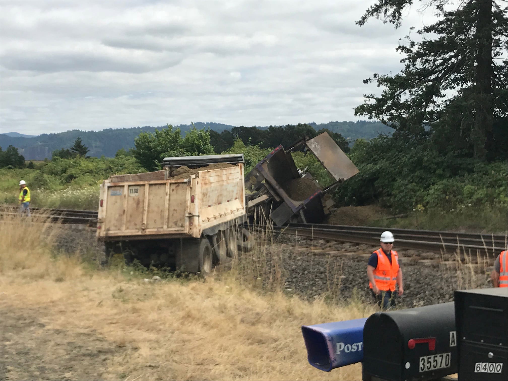 A gravel truck sits on top of railroad tracks east of downtown Washougal after the truck's brakes reportedly failed Thursday afternoon. The driver received minor injuries, and train traffic was delayed.
