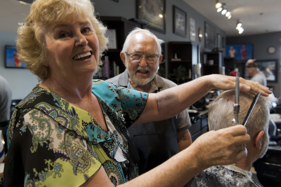 Debbie Wright and Rollie Mayberry, center, recently retired as barbers at Cecil’s Barber Shop, with a combined 105 years of barbershop experience.