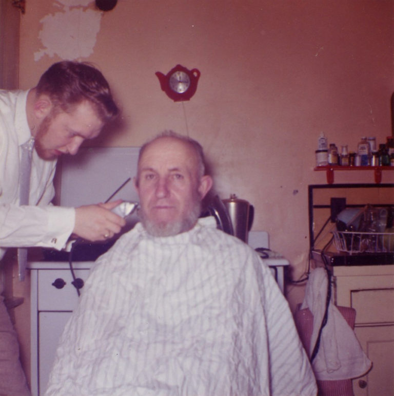 Rollie Mayberry gives his father, Obie, a haircut in 1958, when Mayberry was still in barber school. Mayberry decided to begin cutting hair after his father asked him if he wanted to take over the family farm in South Dakota.