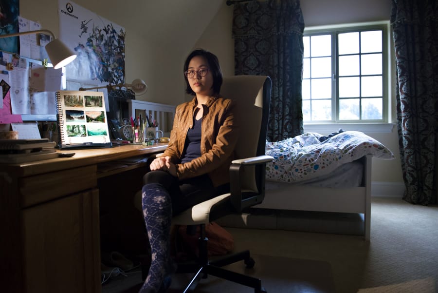 Christine Choi poses for a photo at her drawing desk at her Felida home, along with concept art she created for her imagined game, “Mazu.” Christine won Google Play’s Change the Game design challenge, earning her a $10,000 scholarship.