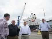 Bruce Reed of Tidewater Transportation &amp; Terminals, from left, talks with Sonny Perdue, Rob Rich of Shaver Transportation and Mark Wilson of Port of Kalama on Wednesday morning, July 4, 2018.