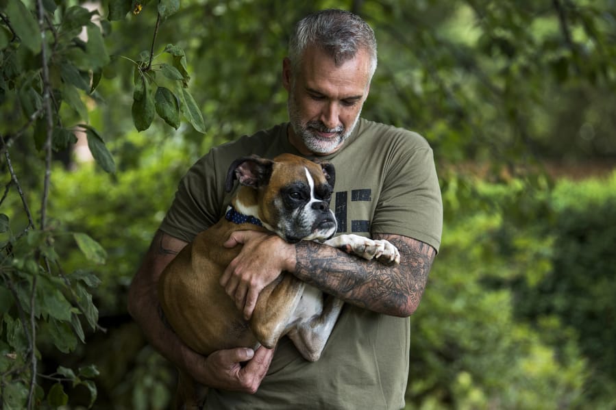 Duncan Lou Who is cradled by one of his owners, Gary Walters, outside Gary and his fiancée Amanda Giese’s home in Washougal. Against all odds, Duncan has made it to his fifth birthday, which was July 14.