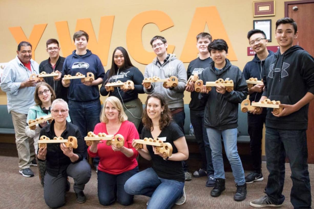 Orchards: Susan Mangin’s Imagine It, Design It, Make It class at Heritage High School, and some of the wood cars and trucks they made, about half of which were donated to YWCA Clark County’s Safechoice program for children affected by domestic violence.