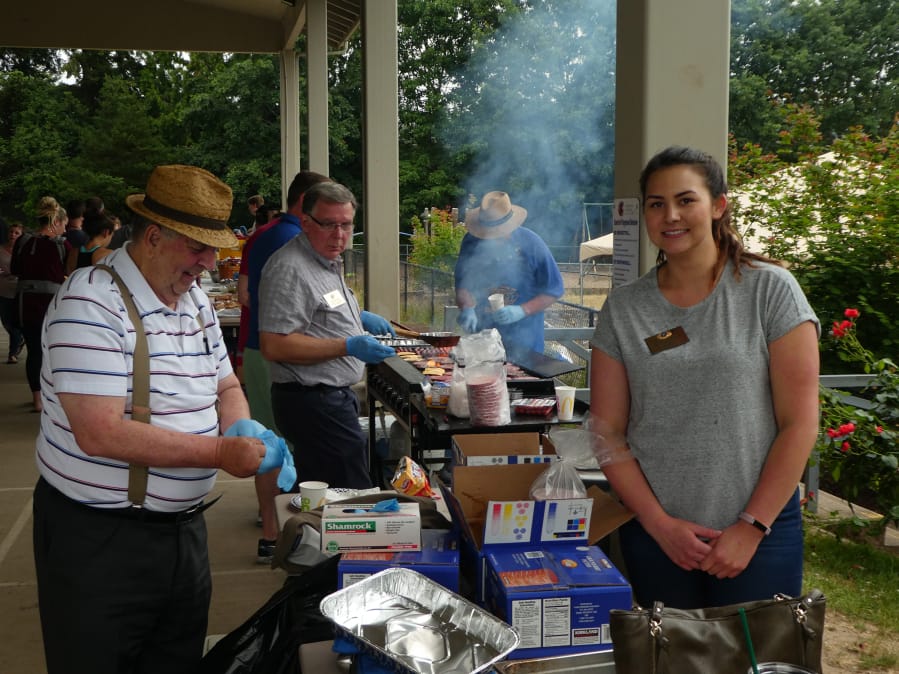 Five Corners: Volunteers serving food at the Cascade Park Kiwanis Club’s annual foster kids barbecue, where they served food to more than 420 children, families and volunteers.