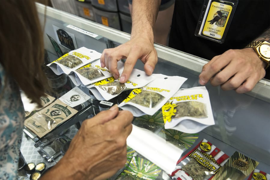 Evie Wilson of Hazel Dell, left, looks at a selection of marijuana while shopping at Sticky’s Pot Shop. The Hazel Dell pot shop faces imminent closure due to a ban on recreational marijuana sales in unincorporated Clark County, and the shop spent Thursday encouraging shoppers to vote in November, when two seats and the chair of Clark County Council are up for reelection.