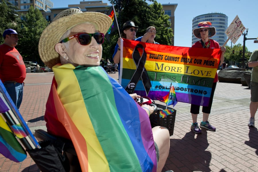 “Lesbian visibility” is the point of the annual Dyke March that’s part of Saturday in the Park Pride, according to organizer Simona Matteucci, who steered a motorized wheelchair and held up a sign reading “Italian lesbians: deal with it.” (James Rexroad for the Columbian)