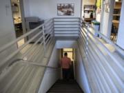 Operations Manager Tim Buck walks downstairs from the second floor offices at the Vancouver Operations Center. Most of the first floor, and all of the second floor of the building is only accessible by stairs and does not meet ADA standards.