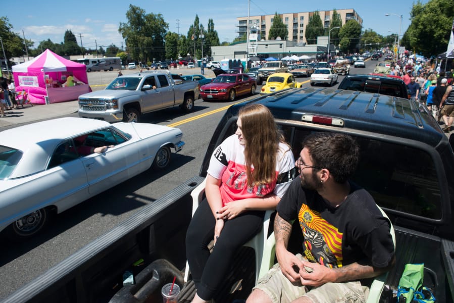 Heather and Tyler Neuharth watch cars drive past on Main Street in downtown Vancouver during Cruise the Couve on Saturday. Cruise the Couve came back for a second year after the event was adopted and renamed by local business owners in 2017.