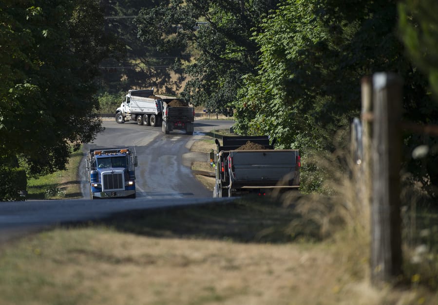 A trio of trucks travel to and from the Zimmerly gravel pit near Washougal.