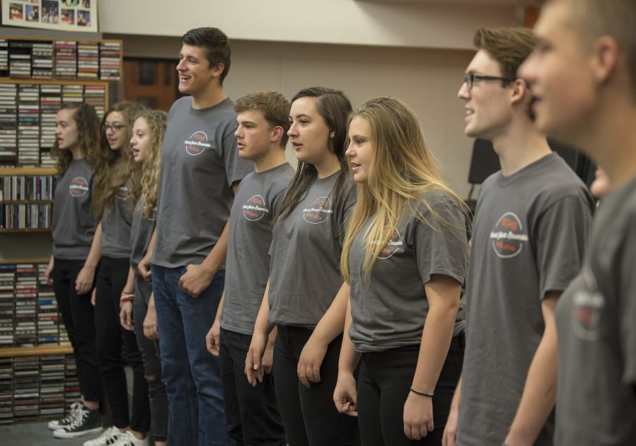 Members of the Battle Ground High School vocal jazz ensemble practice the classic 1980s power ballad “I Want To Know What Love Is” on Thursday in preparation for their Saturday performance with Foreigner.
