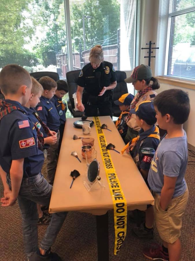 Battle Ground: Battle Ground Police Department Lt. Kim Armstrong shows a Battle Ground-based Cub Scouts pack a crime scene during the pack’s visit to the station.